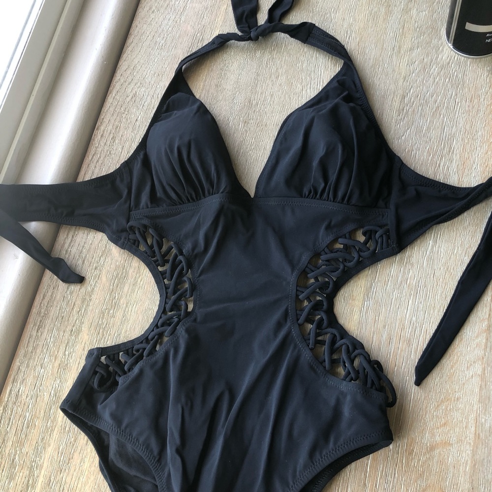 Black one piece bathing suit with knot detailing.